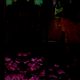 Artificial flowers next to a mirror underneath a heavily scarved, low-watt lamp.